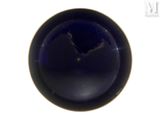a blue bowl with a hole in it on a white surface