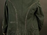 an image of a green jacket on a mannequin stand