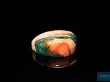 an image of a ring with a blue and orange stone