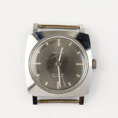 a watch that is sitting on a white surface
