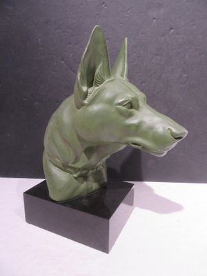 sculpture of a dog ' s head on a black base