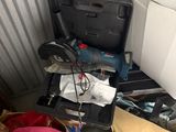 a pile of junk in a storage room with a drillet and other items