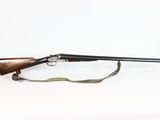 an old rifle with a wooden barrel and a sling on a white background