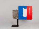 an image of a french flag with a stone block in front of it