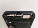 the back of a black cell phone with a broken battery