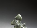 an image of a statue of a man sitting on top of a rock