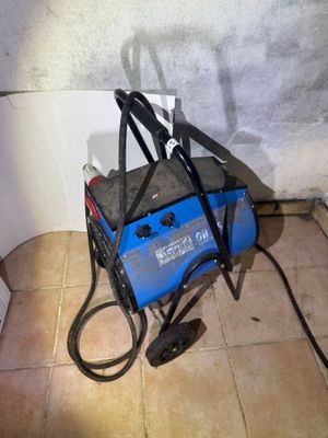 a blue and black welding machine sitting on the floor