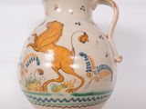 a vase with a lion on it sitting on a table