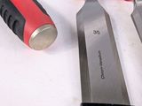 three knives that are sitting next to each other on a table