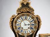 a clock that is sitting on a table next to a box