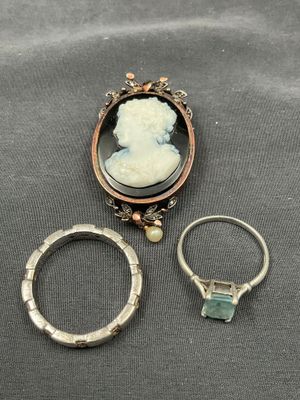 a close up of two rings and a ring with a picture of a woman