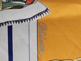 a close up of a shirt with a picture of a person on a surfboard