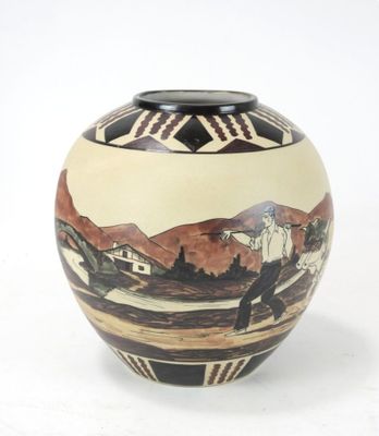 a vase that has a picture of a town on it