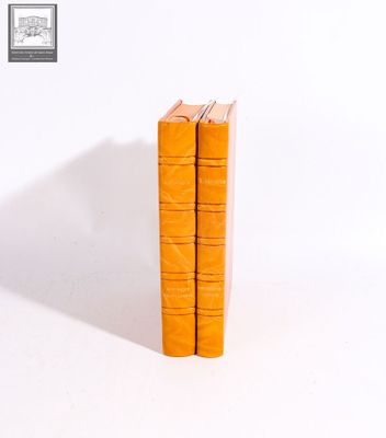 two books sitting on top of each other on a white surface