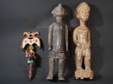 two wooden figurines of a man and a woman on a black background