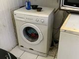 a washer and a dryer in a small room