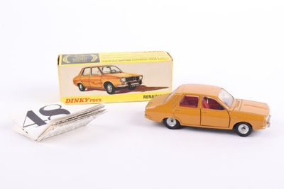 an orange toy car and a box of paper