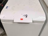 two washing machines sitting next to each other on the floor