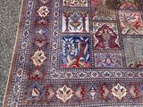 a rug on the ground with a cat standing next to it