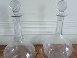 three glass decantes sitting on a marble table