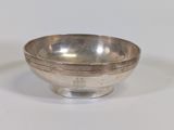 an image of a silver bowl sitting on top of a white table