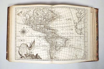 an old book with a map of the americas on it