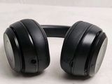 a pair of black headphones sitting on a table