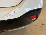 a sticker on the back of a white car