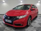 a red honda civic is parked in a showroom