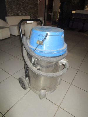 un aspirateur posé sur le carrelage du salon