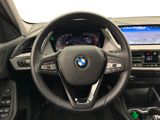 the interior of a bmw vehicle with a steering wheel and dashboard controls