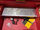 a red tool box with tools in it on a table