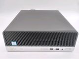 the hp desktop computer is on a white surface with a blue sticker on it