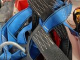 a pile of blue and black straps on a table
