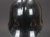 a helmet on a stand on a gray background