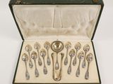 six spoons in a case with a spoon in it