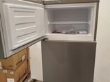an open refrigerator in a warehouse with boxes in the background