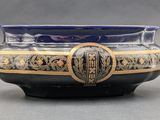 a blue and gold bowl with a design on it