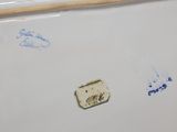 a picture of a piece of porcelain with a wooden handle on it