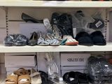 many pairs of shoes on the shelves in the store