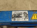 a close up of a blue machine with a sign on it