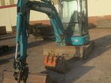a small excavator that is sitting in the dirt