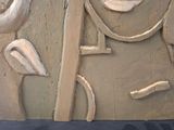 a clay sculpture of a woman ' s face on display