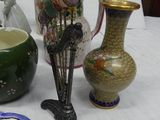 several vases and plates are sitting on a table with a white table cloth
