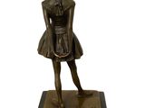 bronze statue of a woman holding a tennis racquet on a marble base