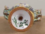a close up of a vase with a dragon on it