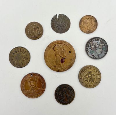 an assortment of old coins sitting on top of a white surface