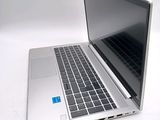 a silver laptop computer sitting on a white surface