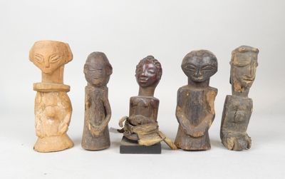 several wooden figurines of different shapes and sizes on a white surface