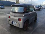 a small car that is parked in a parking lot